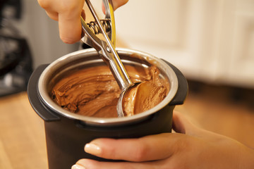 Scooping chocolate ice cream.