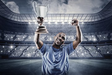 Wall Mural - Composite image of happy sportsman looking up and cheering