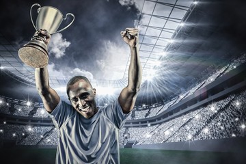 Wall Mural - Composite image of portrait of happy sportsman cheering