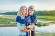 © Mila Supinskaya  - Beautiful senior couple standing in front of the river in autumn