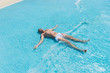 © kolotype - Young Man Lying on Back in Shallow Waves of Pool