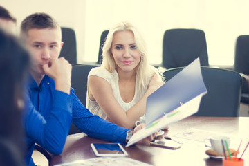 Young beautiful blonde business woman listening intently his col