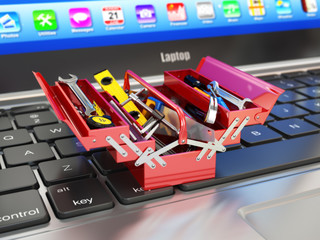 Laptop and toolbox with tools. Online support.