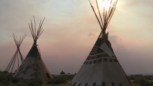 Indian Teepees Stand In A Native American Encampment At Sunset.