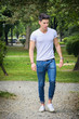 Handsome young man in white t-shirt outdoor in city park