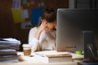 © shefkate - A portrait of a businesswoman staying late in the office with a