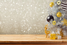 Christmas Holiday Background With Christmas Tree And Decorations On Wooden Table. Black, Golden And Silver Ornaments
