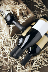 Poster - Wine bottles in wooden box and straw