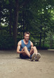 © Flamingo Images - Fit Man Sitting at the Park and Flexing his Legs