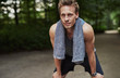 © Flamingo Images - Athletic Man Resting After Jogging at the Park