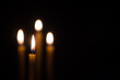 © Tony A - yellow candle lit on black background.