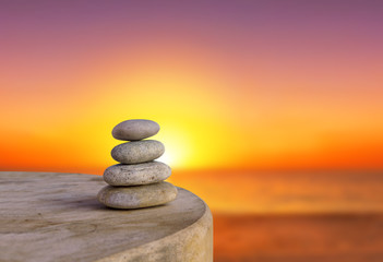 Balanced several Zen stones on blurred beautiful the beach backg