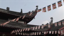 Flags Hang From The Eaves Of A Chinese Temple.