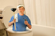 © Michael O'Keene - Humorous plumber inside toilet with tools and toilet paper