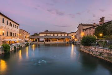 Canvas Print - View on thermal bath in the medieval Tuscan town at dusk.