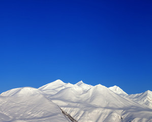 Snowy mountains and blue clear sky  in morning