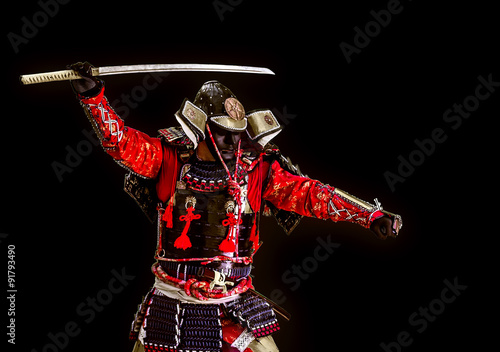 Fotografia Samurai in ancient armor with a sword attack