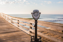 Coing-Operating Sightseeing Binoculars With Beach Background On The Virginia Beach Fishing Pier