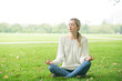 Young woman meditating and Yoga in a park