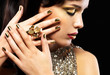 Beautiful woman with golden nails and fashion makeup