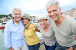 © goodluz - Portrait of cheerful senior people enjoying trip