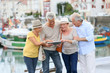 © goodluz - Senior couples looking at map on traveling journey