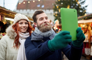 Canvas Print - couple taking selfie with tablet pc in old town