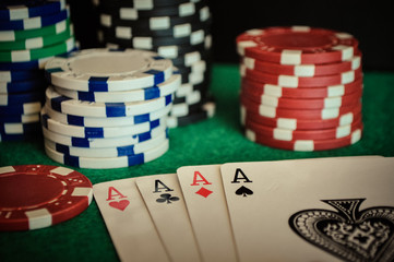 Poker Chips on a gaming table with cards