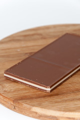 Brown white chocolate on a wooden board