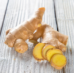 Fresh ginger root on wooden background.