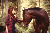 Fototapeta Konie - Redhead girl with horse