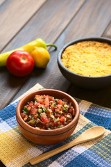 Poster - Traditional Chilean Pebre sauce made of tomato, onion, aji verde (small green hot pepper), lemon juice and coriander leaves photographed with natural light (Selective Focus, Focus in middle of pebre)