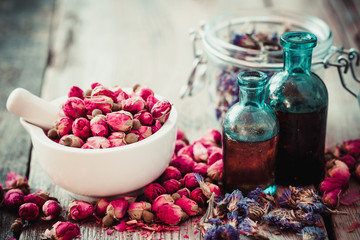 Wall Mural - Mortar with rose buds, bottles of tincture and dried forget me n