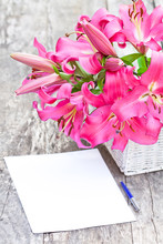 Pink Lily Flowers Bouquet And Blank Paper Sheet With Pen On Rust