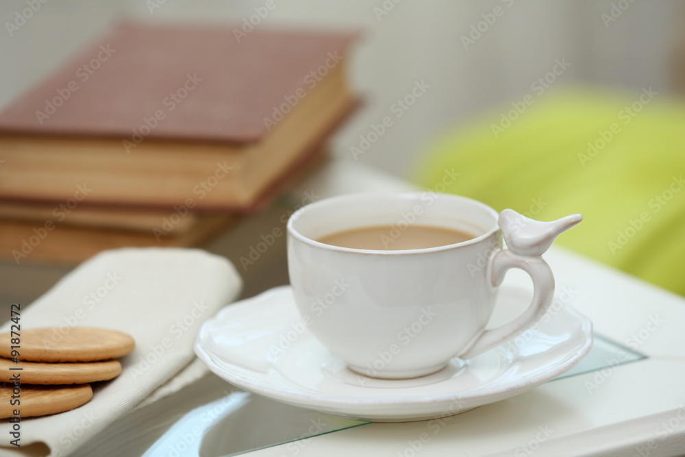 Cup of coffee on table in living room