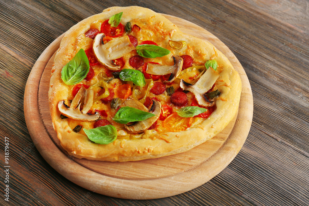 Heart shaped pizza on wooden background