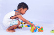 © napatcha - a little asian boy play building brick on white background
