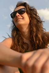 Wall Mural - Portrait of a happy woman in sunglasses