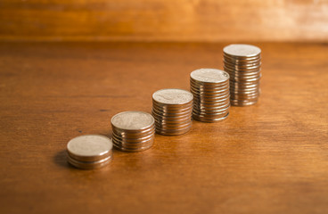 Silver coins stacked in a row.