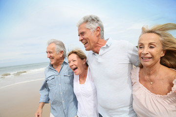 Canvas Print - Senior people walking on the beach