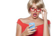 Shocked beautiful blonde with short hair reading a text message