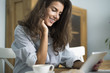 © gpointstudio - Woman browsing her digital tablet in the morning