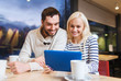 © Syda Productions - happy couple with tablet pc and coffee at cafe