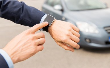 Wall Mural - close up of male hands with wristwatch and car