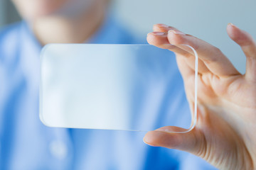 Poster - close up of woman with transparent smartphone