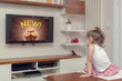 © Myst - cute little girl watching advertisement on tv