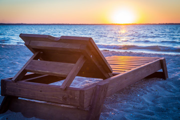 Sunbed on the beach at sunset