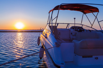 Yacht near the pier against sunset