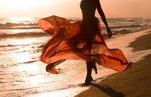 Beautiful Woman With Flying Red Dress, Beach