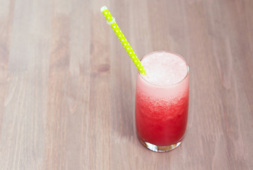 A glass of healthy watermelon smoothie on wooden background